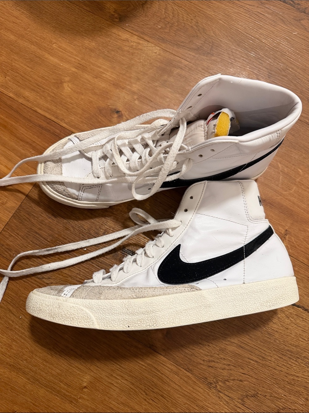 Nike White High-Top Sneakers with Black Swoosh